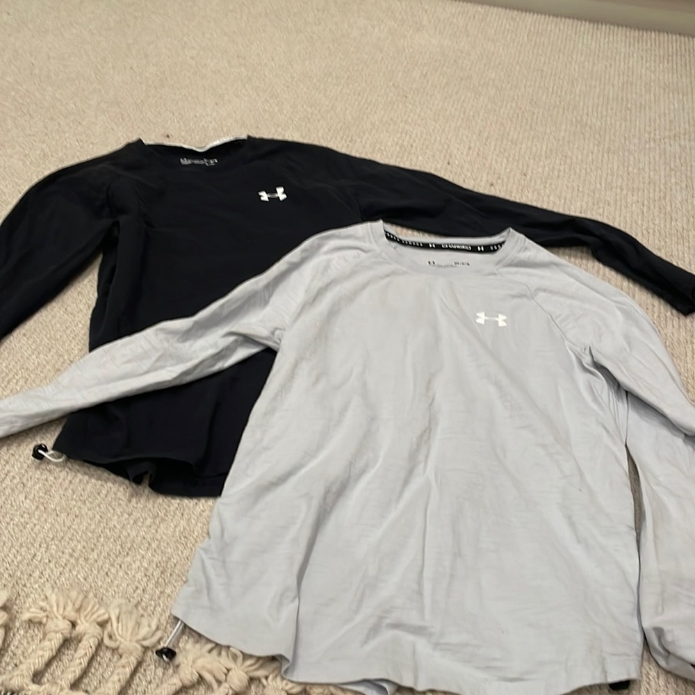 Two UA “Charged” long sleeves shirts size M